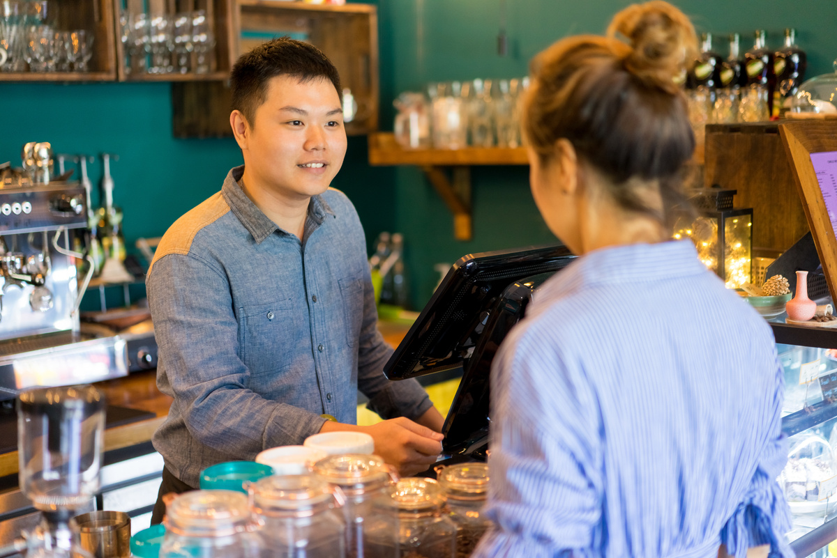 Positive Confident Cashier Taking Customers Order